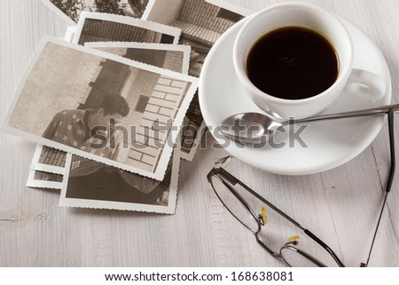 Memories. Cup of coffee and old photos