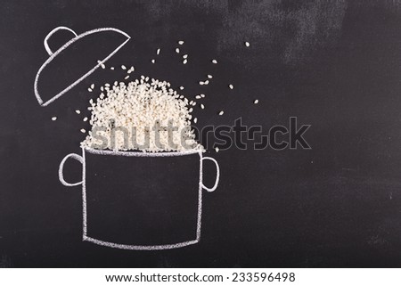 Drawn pot and real rice on the chalkboard with copy-space