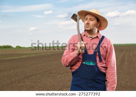 Agricultural worker posing on corn field with copy space