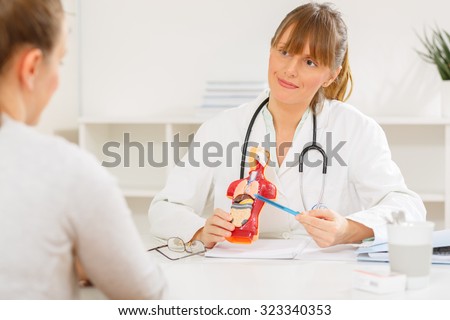 Female doctor explaining to her patient how internal organs work