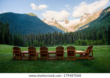 wood chairs looking at a mountain vista
