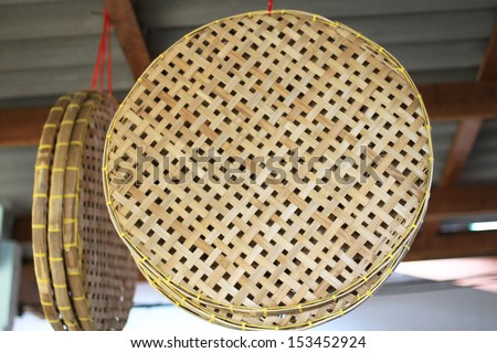 Flat basket made from bamboo hanging for sale, Thailand traditional basket