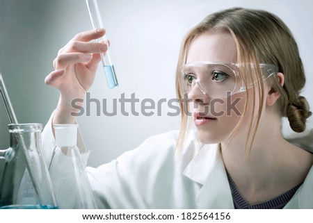 young woman in laboratory with tube