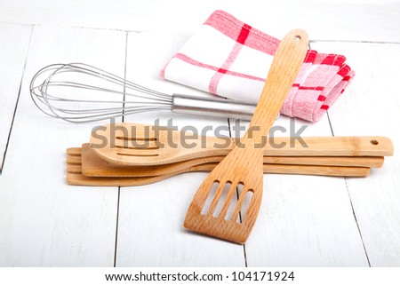Wooden kitchen set with tea towel, on wooden white background.