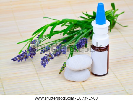 Lavender herb flower leaf springs with an aromatherapy essential oil dropper bottle.
