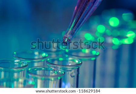 Pipette adding fluid to one of several test tubes