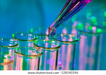 Pipette adding fluid to one of several test tubes