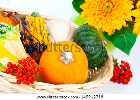 Autumn pumpkins in a straw basket