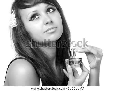 Young woman applying perfume on her neck.