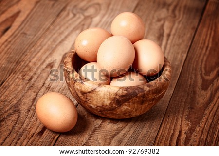 fresh brown eggs on wooden background