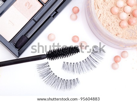black false eyelashes with mascara and powder, on white background