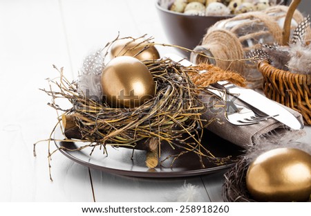 table decoration on white wooden background with Chicken golden egg