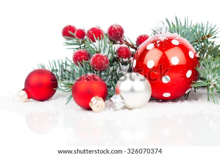 Christmas balls and fir branches with decorations isolated over white