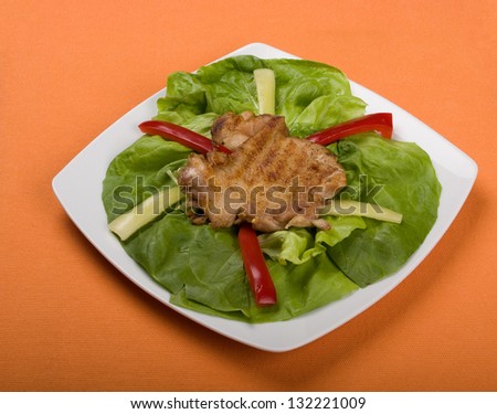 Different types of food plates, cakes, red meat isolated on orange background