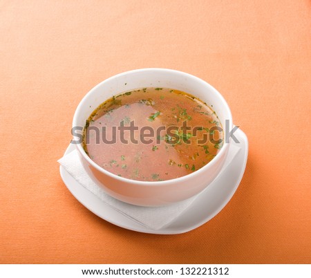 Different types of food plates and soup isolated on orange background