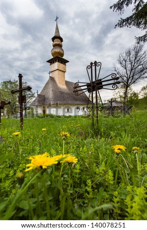 Old church isolated on a green grass background and yellow flowers
