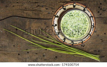 Spring chive  Smoothie with yogurt on old table in brown dish