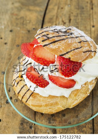 Cream Puffs with strawberries for Breakfast , pink  service on white background