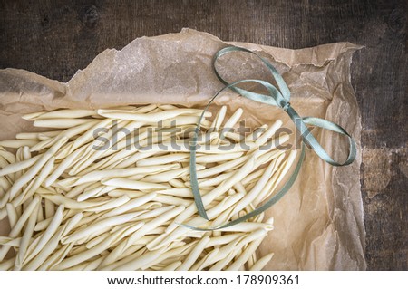 homemade noodles, fileja, with green bow, packing in wrinkled paper, close up