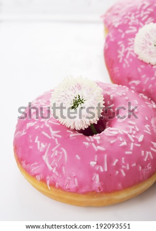 Doughnuts with pink glaze and white flowers