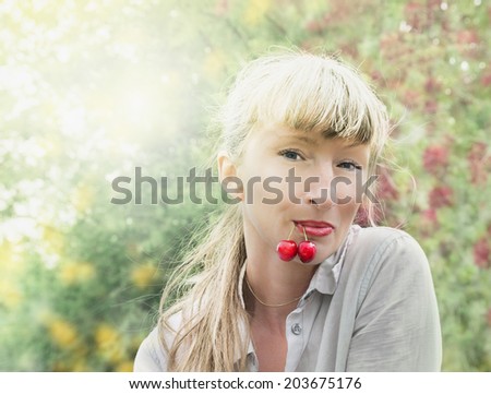 Woman with cherry in mouth