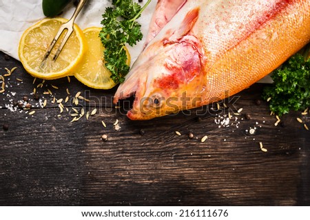 raw rainbow trout fish preparation on old wooden table, food background, top view