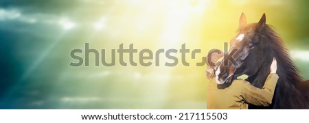 Man and horse against backdrop of  sun rays on autumn sky, banner for website
