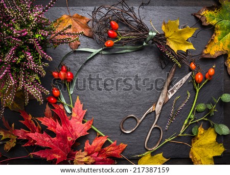 Florist table for Making autumn decorations with leafs,shears and ribbon, fall background with copy space