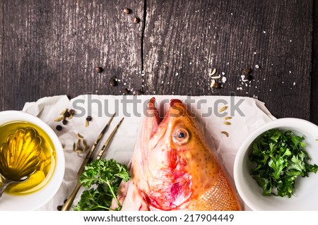 Rainbow trout,oil and spices on white paper, food background with copy space