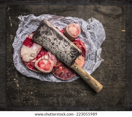 Raw Meat set for broth in paper and vintage cleaver on dark wooden table, top view, food background