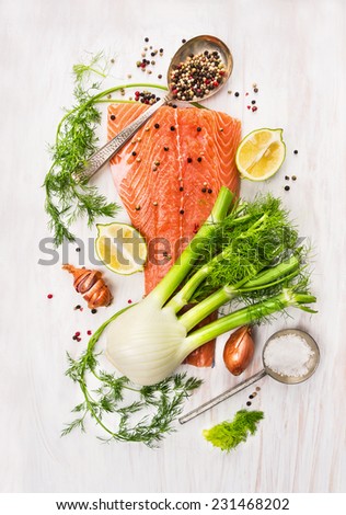 Preparation with raw salmon fillet,fennel, dill, lemon and onion on white wooden background, top view