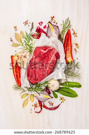 Raw meat, composing with herbs,spices and seasoning on white wooden background, ingredients for cooking, top view