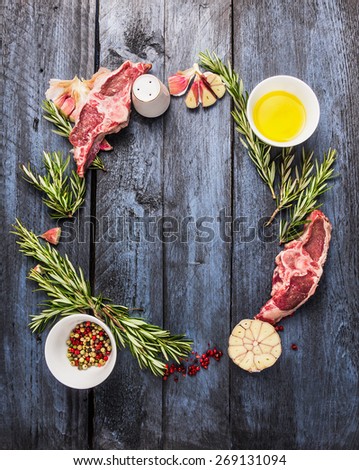 raw lamb meat circle frame with rosemary herbs, garlic and oil, on  blue wooden background, top view