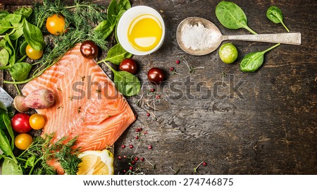 Raw salmon fish fillet with spoon of salt, fresh herbs and spices on rustic wooden background, top view, banner for website with cooking concept.