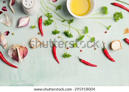 Chili peppers , oil, and fresh herbs and spices for cooking, top view