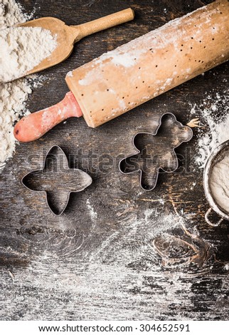 Christmas cookies baking. Preparation with bake molds, rolling pin and flour on wooden background, top view