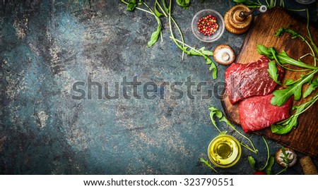 Raw Beef steak and fresh ingredients for cooking on rustic background, top view, banner.  Healthy and diet food concept.