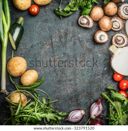 Fresh organic seasonal garden vegetables for cooking on rustic wooden background, top view, frame, place for text.  Vegan food , vegetarian , diet or healthily cooking concept.