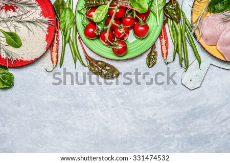 Chicken breast with  rice, fresh  delicious vegetables and ingredients for tasty cooking on rustic wooden background, top view,border. Diet or Sports nutrition concept