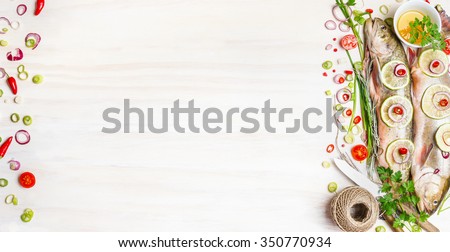 Fresh char fish with herbs, spices and ingredients for tasty cooking on white wooden background, top view, banner.  Healthy food or diet nutrition concept.