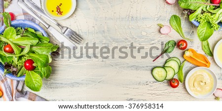 Various green organic salad ingredients on  light rustic background, top view, banner. Healthy  lifestyle or detox diet food  concept