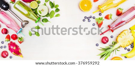 Colorful Smoothie bottles with fresh ingredients and blender on white wooden background, top view, banner. Superfoods and healthy lifestyle or detox  diet food concept.