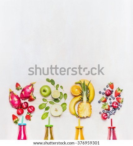 Healthy fruits smoothies with colorful ingredients  on white wooden background, top view, place for text.  Superfoods and healthy lifestyle or detox  diet food concept.