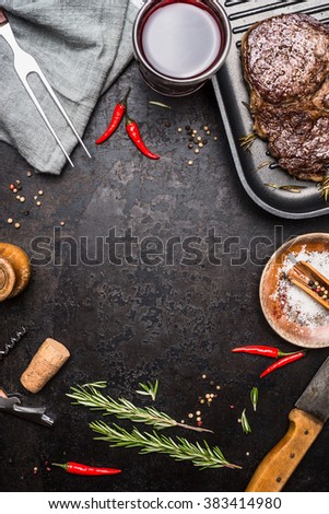 Food background with grilled Steak Ribeye on grill iron pan on rustic metal background with red wine, herbs and spices, top view. Meat food