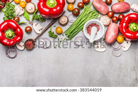 Variety of fresh organic vegetables and seasoning for tasty vegetarian cooking with mortar, pestle and wooden spoon on gray concrete texture background, top view, banner. Healthy lifestyle concept.