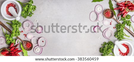 Cooking background with spices mortar , wooden spoon and various fresh seasoning on gray stone background, top view, banner.