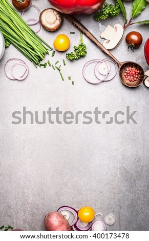 Healthy cooking with fresh vegetables and seasoning ingredients on rustic stone background, top view, place for text., frame. Healthy lifestyle and diet food concept.
