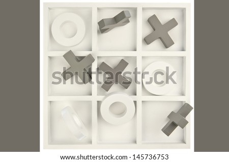 Wooden noughts and crosses game board in gray and white colors and mixed stones isolated in white background