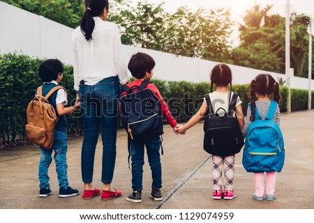Family children kid son girl and boy kindergarten walking going to school holding hand with mother mom, back to school concept
