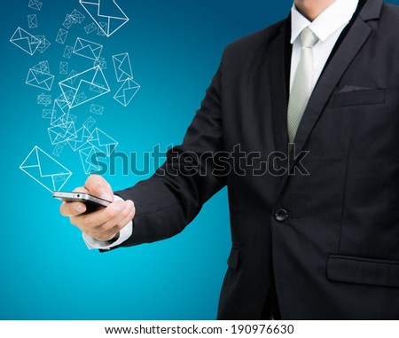 Businessman standing posture hand hold mobile phone send mail isolated on blue background